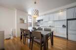 Modern condo with open concept kitchen and dining area, perfect for entertaining.