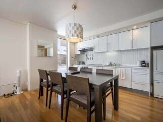 Modern condo with open concept kitchen and dining area, perfect for entertaining.