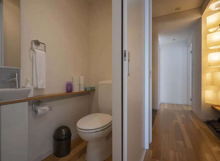 Modern and minimalist bathroom with a sleek toilet and sink.