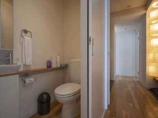 Modern and minimalist bathroom with a sleek toilet and sink.