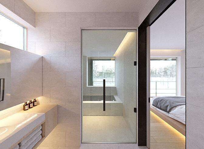 Modern bathroom with sleek design and floor-to-ceiling windows offering natural light.