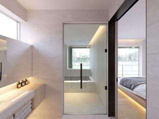 Modern bathroom with sleek design and floor-to-ceiling windows offering natural light.
