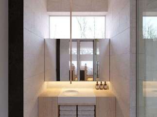 This stunning bathroom boasts a minimalist design with light beige tiles and wooden vanity.