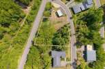 Nestled in a wooded area, this lot offers a tranquil setting with easy access to roads.