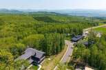 Luxury homes nestled in a serene forest setting, offering breathtaking mountain views.