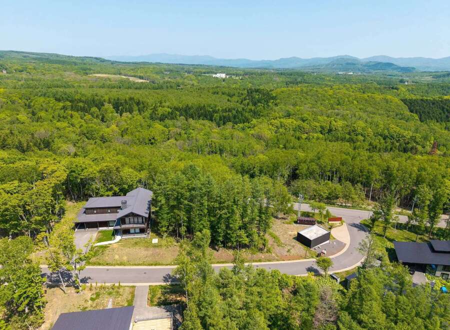 Nestled in a lush forest with mountain views, this stunning property offers a tranquil escape.