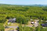 Nestled in a lush forest with mountain views, this stunning property offers a tranquil escape.