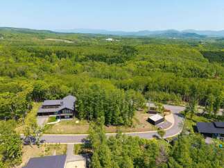 Nestled in a lush forest with mountain views, this stunning property offers a tranquil escape.