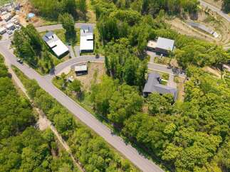 Nestled in a lush forest, this secluded property offers a tranquil escape with modern homes.