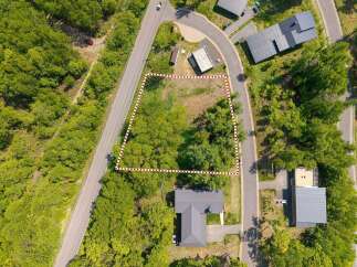 Nestled in a wooded area, this lot offers a tranquil setting with easy access to roads.