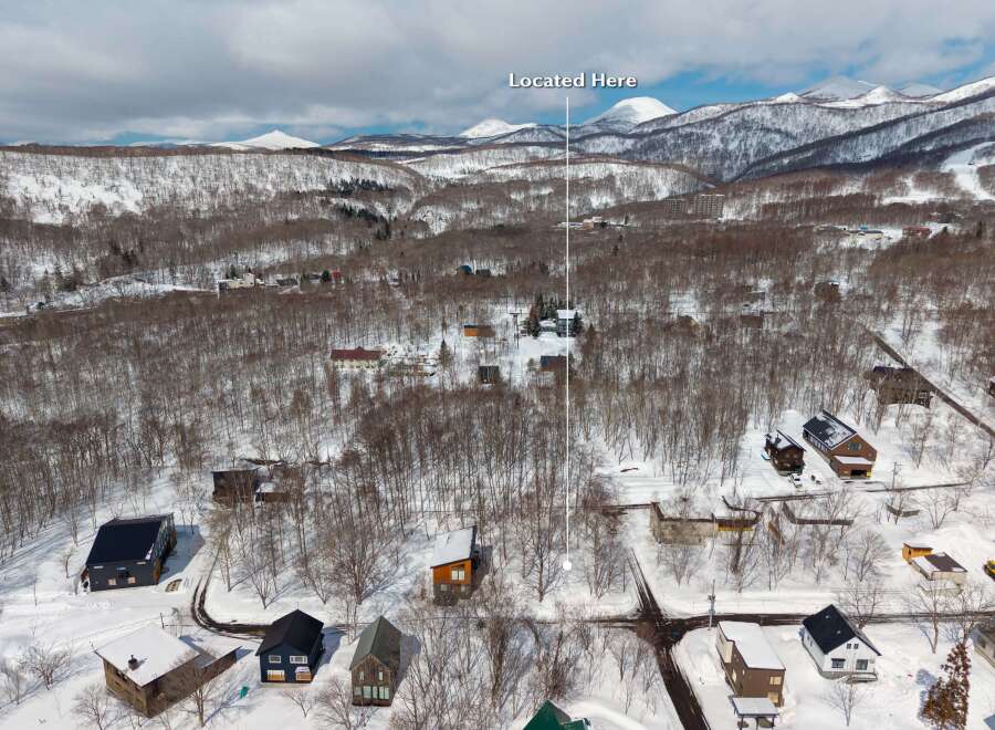 Nestled in a snowy landscape, this charming home offers breathtaking mountain views.