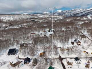 Nestled in a snowy landscape, this charming home offers breathtaking mountain views.