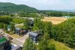 Nestled in a serene mountain setting, this stunning property boasts modern, architecturally-designed homes with expansive windows and sleek metal roofs.