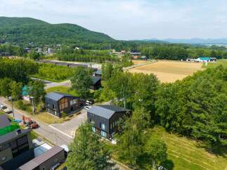 Nestled in a serene mountain setting, this stunning property boasts modern, architecturally-designed homes with expansive windows and sleek metal roofs.