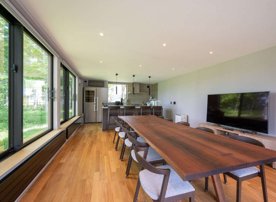 This stunning property boasts a spacious open-plan living area with floor-to-ceiling windows offering breathtaking views.
