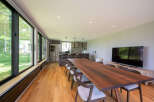 This stunning property boasts a spacious open-plan living area with floor-to-ceiling windows offering breathtaking views.