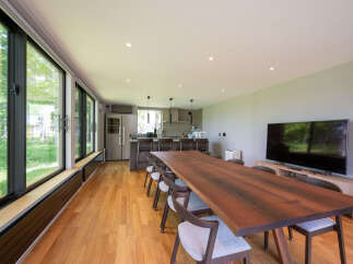 This stunning property boasts a spacious open-plan living area with floor-to-ceiling windows offering breathtaking views.