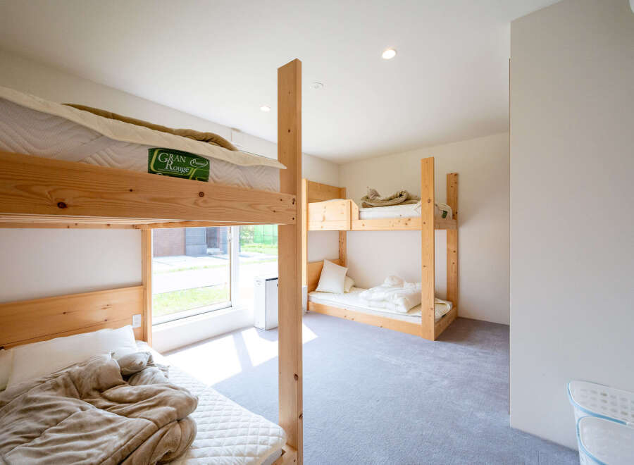 Cozy bunk beds in a bright room with natural light.