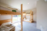 Cozy bunk beds in a bright room with natural light.