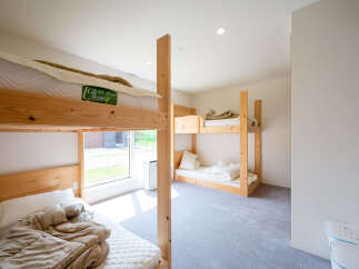 Cozy bunk beds in a bright room with natural light.
