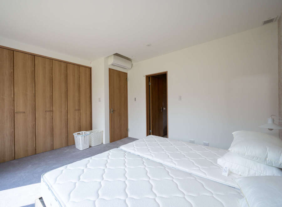 This bright and airy bedroom features a clean, minimalist design.