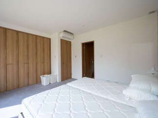 This bright and airy bedroom features a clean, minimalist design.