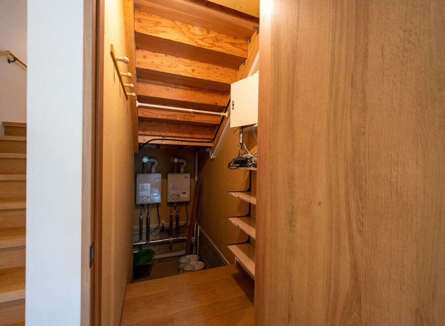 This home boasts a unique under-stair storage area, complete with built-in shelving and ample space for various items.