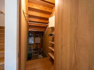 This home boasts a unique under-stair storage area, complete with built-in shelving and ample space for various items.