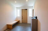 This modern entryway boasts a minimalist design with clean lines and a neutral color palette.