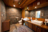 This stunning bathroom boasts a unique blend of rustic wood and modern tile, creating a serene and stylish atmosphere.