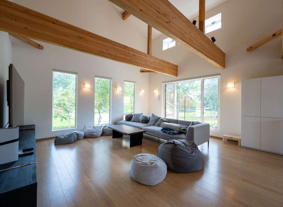 Spacious living room with large windows offering abundant natural light and views of the surrounding landscape.