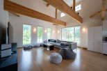 Spacious living room with large windows offering abundant natural light and views of the surrounding landscape.