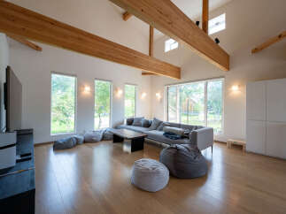 Spacious living room with large windows offering abundant natural light and views of the surrounding landscape.