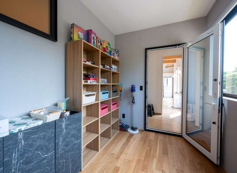 This stunning property boasts a dedicated playroom, complete with built-in shelving for games and toys.