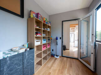 This stunning property boasts a dedicated playroom, complete with built-in shelving for games and toys.