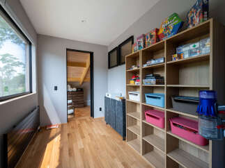 This stunning property boasts a dedicated playroom, complete with built-in shelving for games and toys, creating a fun and organized space for children.