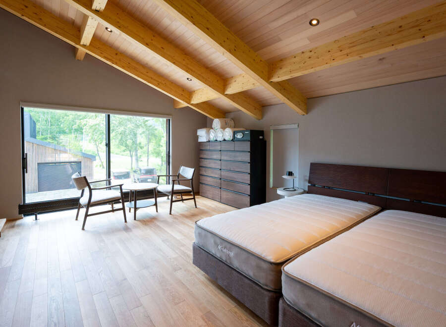 This stunning bedroom boasts a spacious layout with a king-size bed, large windows offering scenic views, and a cozy sitting area.