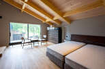 This stunning bedroom boasts a spacious layout with a king-size bed, large windows offering scenic views, and a cozy sitting area.