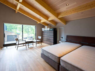This stunning bedroom boasts a spacious layout with a king-size bed, large windows offering scenic views, and a cozy sitting area.