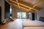 This stunning bedroom boasts a spacious layout with a cozy sitting area and large windows offering breathtaking views.