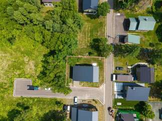 Nestled in a serene wooded area, this modern home boasts a spacious lot and private driveway.