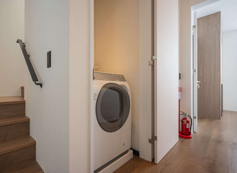 Modern apartment laundry room with washer and dryer tucked away in a closet.
