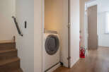 Modern apartment laundry room with washer and dryer tucked away in a closet.