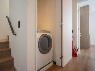 Modern apartment laundry room with washer and dryer tucked away in a closet.