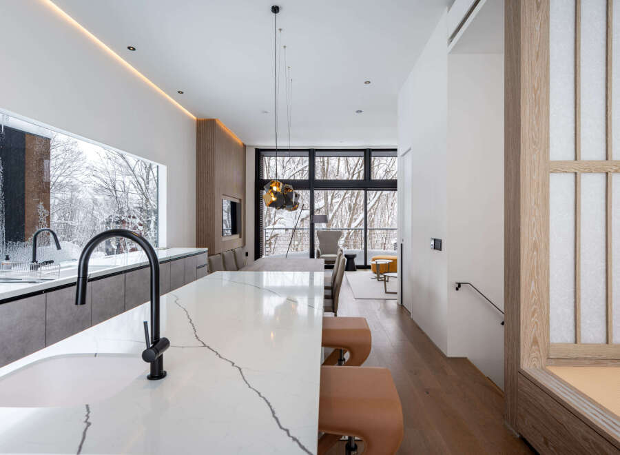 Stunning modern kitchen with marble countertops and a sleek island, perfect for entertaining.