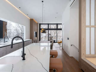 Stunning modern kitchen with marble countertops and a sleek island, perfect for entertaining.
