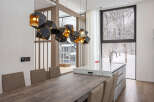 Modern kitchen with stunning mountain views and a unique geometric light fixture.