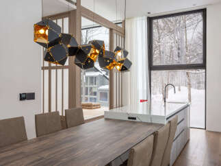 Modern kitchen with stunning mountain views and a unique geometric light fixture.