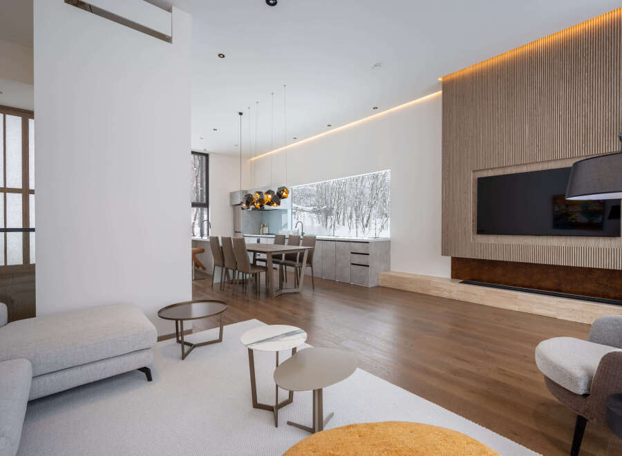 Stunning modern living space with open floor plan, seamlessly connecting the kitchen and living room.