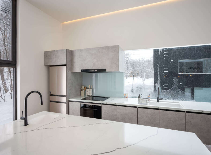 Modern kitchen with sleek countertops and integrated appliances.